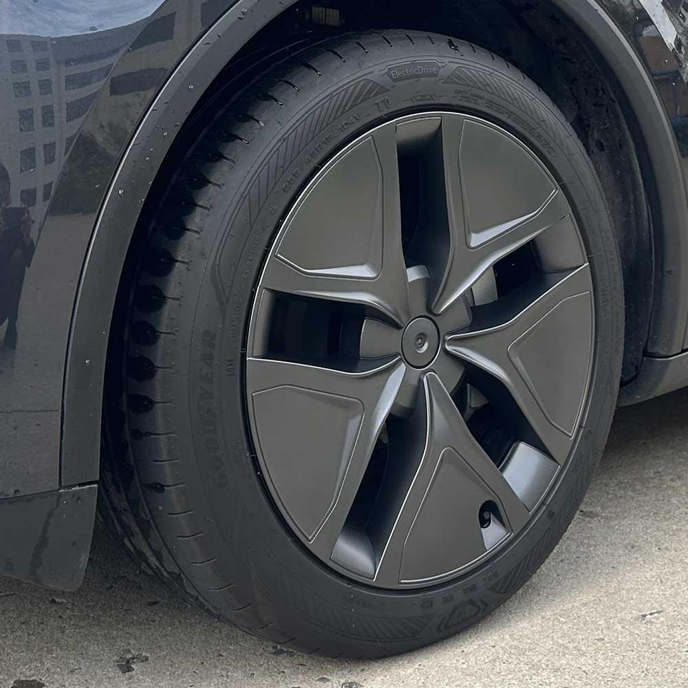 Side view of the 19-inch Arachnid style aero wheel cover installed on Model Y