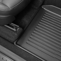 Custom-fit TPE floor mat installed in the driver's footwell of Model Y