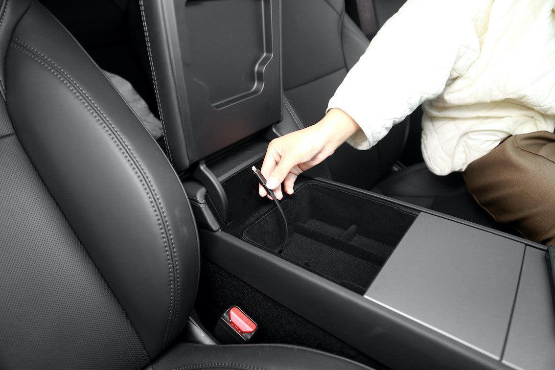 Armrest organiser tray providing easy access to items stored beneath the tray