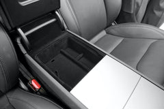 Armrest organiser tray creating organised storage for small essentials in the centre console