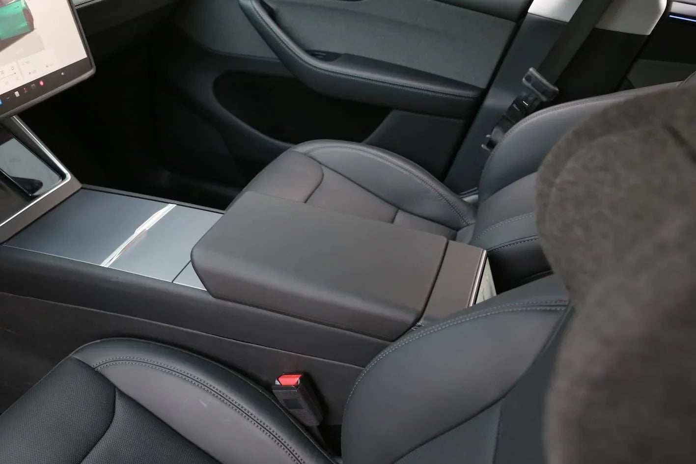 Interior view showing the armrest protector fitted in Model 3 and Model Y