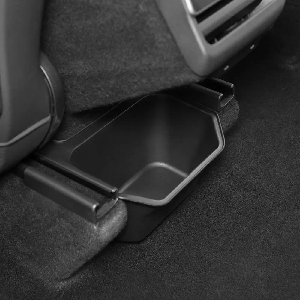 Side view of the backseat storage bin fitted under the rear centre console