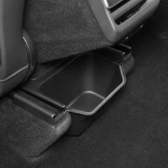 Side view of the backseat storage bin fitted under the rear centre console