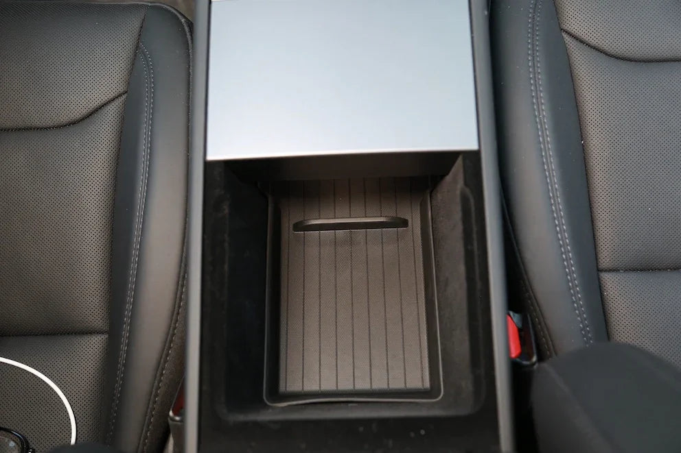 Lower armrest organiser liner installed inside the centre armrest of Model Y