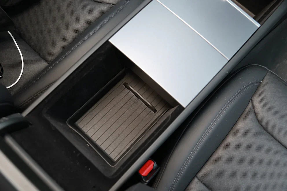 Top view of the TPE lower armrest organiser liner fitted in Model Y