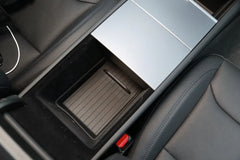 Top view of the TPE lower armrest organiser liner fitted in Model Y