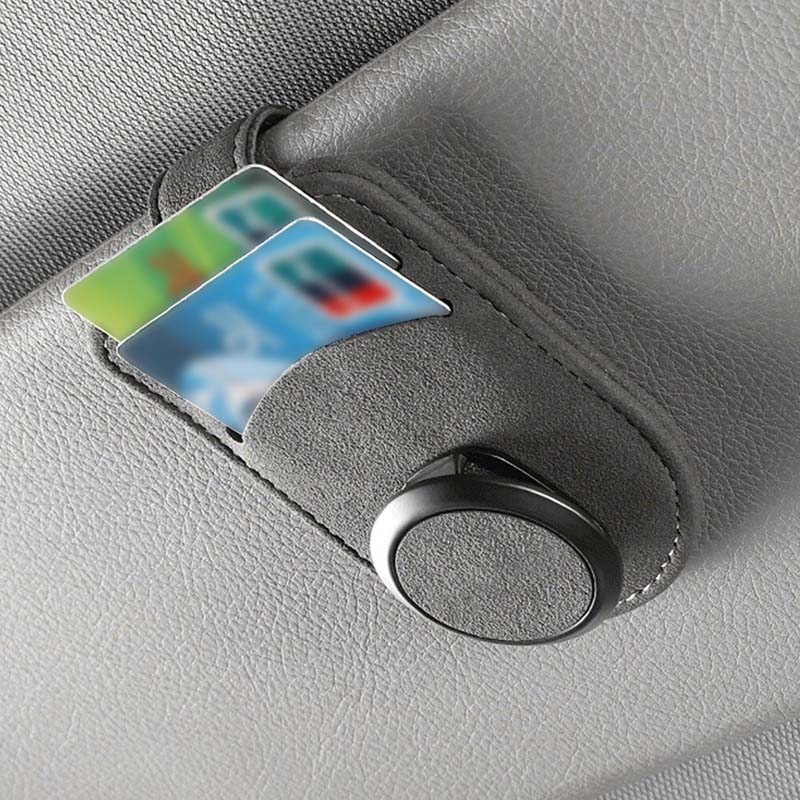Car glasses holder clip holding a card on the sun visor