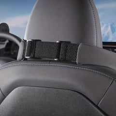 Rear view of the black neck support pillow secured with an adjustable strap