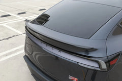 Rear three-quarter view of Model Y with the performance spoiler installed