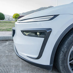 Side view of the wind deflector headlight trim installed on Model Y
