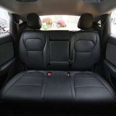 Black microfibre leather seat covers fitted across the Model Y rear cabin