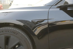 Side view of Model Y with matt black side indicator camera caps installed