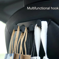 Front seat back hook holding shopping bags and personal items