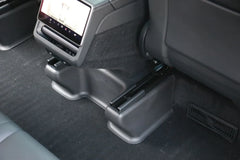 Under seat carpet protector viewed from behind the front passenger seat