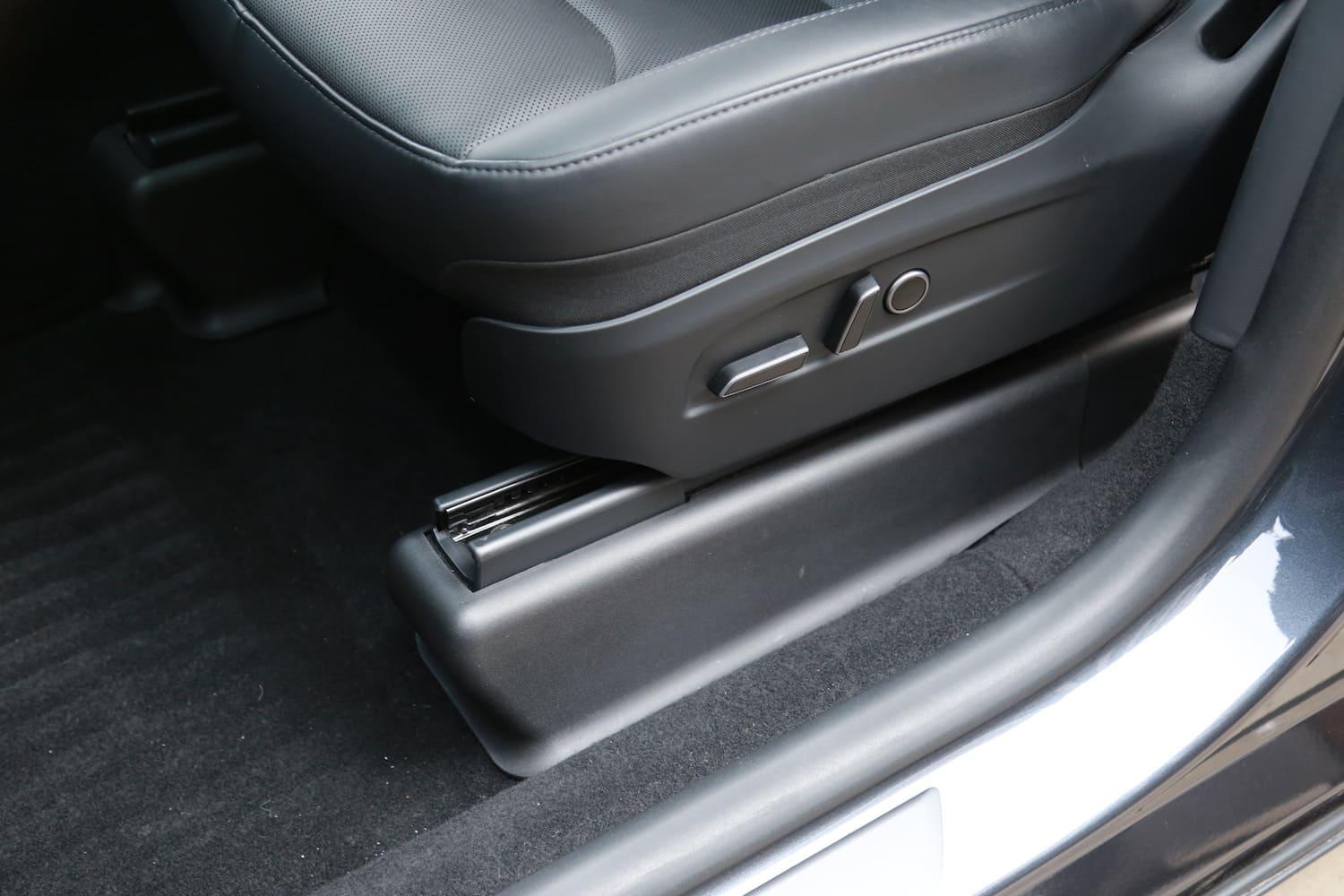 Under seat carpet protector installed beneath the front passenger seat