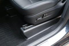 Under seat carpet protector installed beneath the front passenger seat