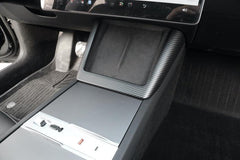 Carbon fibre wireless phone charger surround installed on the centre console