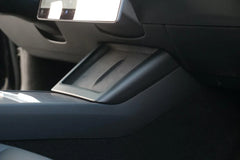 Matt black wireless phone charger surround enhancing the Tesla centre console