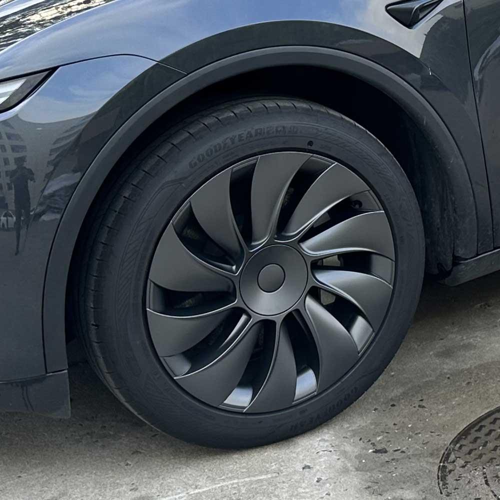 Side view of the 19-inch TurboFlow wheel cover installed on Model Y