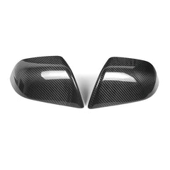 Genuine carbon fibre rear view mirror covers for the 2024 Tesla Model 3 Highland, shown as a high-gloss pair against a white background.