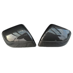 Glossy carbon-fiber-look rear view mirror covers for Tesla Model Y (2025 Juniper), displayed as a pair on a white background.