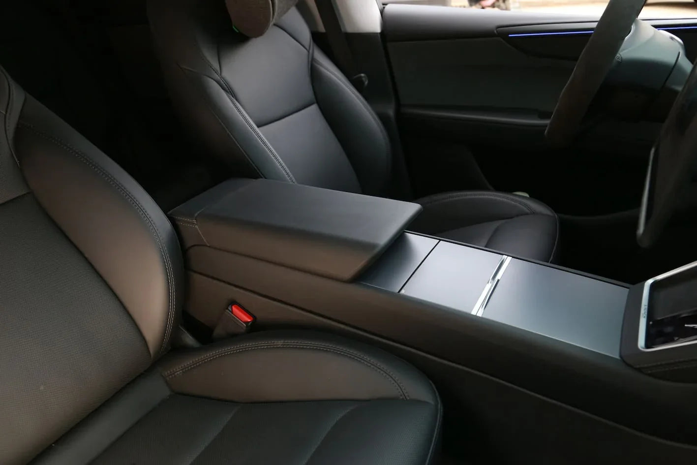 Precision-moulded armrest protector providing a seamless fit on the factory armrest