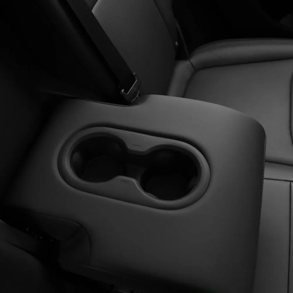 Silicone rear cup holder insert installed in the rear centre armrest of Model Y
