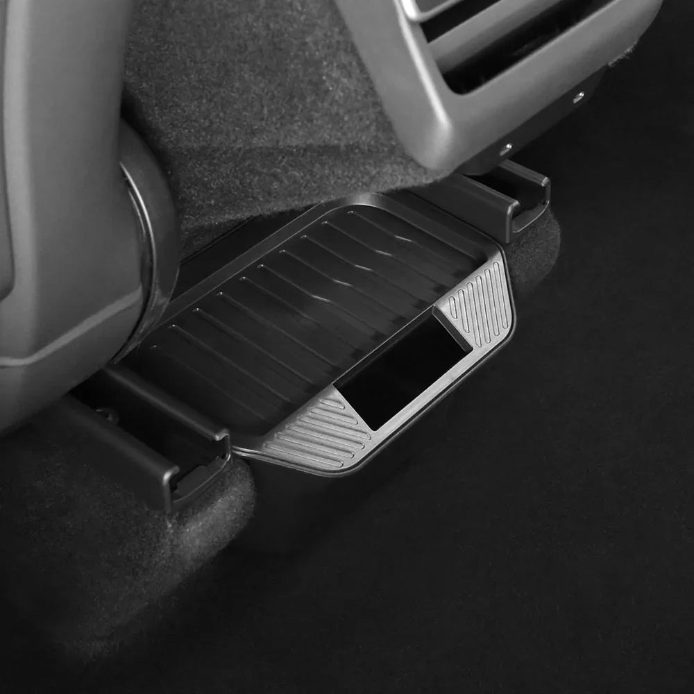 Backseat storage bin installed beneath the rear centre console of Model Y (2025–2026)