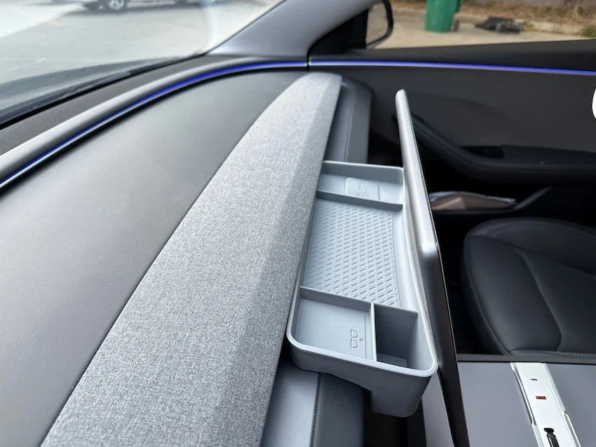 Dashboard screen rear storage tray providing extra storage behind the display