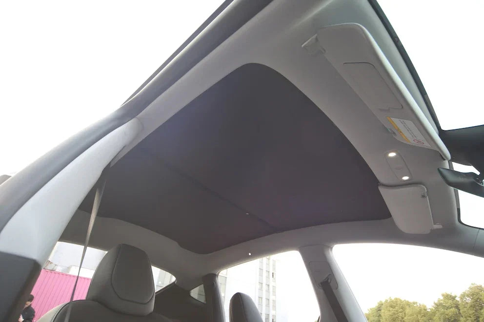 Side view of the glass roof sunshade installed on Model Y (2025–2026)