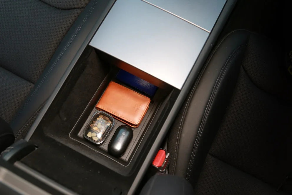 Lower armrest organiser liner storing small essentials while keeping the centre console organised