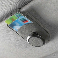 Car glasses holder clip holding a card on the sun visor