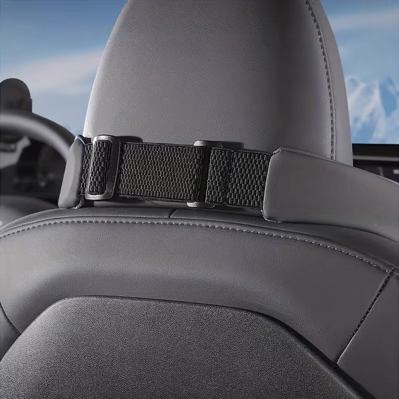 Rear view of the black neck support pillow secured with an adjustable strap
