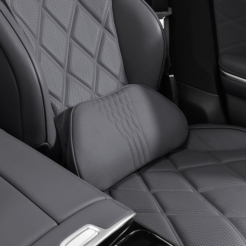 Black Nappa leather neck and lumbar support pillows installed on a front seat