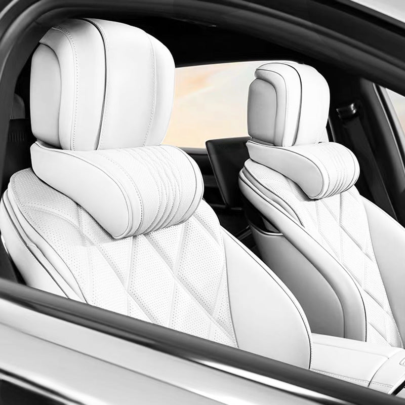 White neck and lumbar support pillow sets installed on both front seats