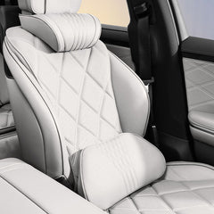 White Nappa leather neck and lumbar support pillows installed on a vehicle seat