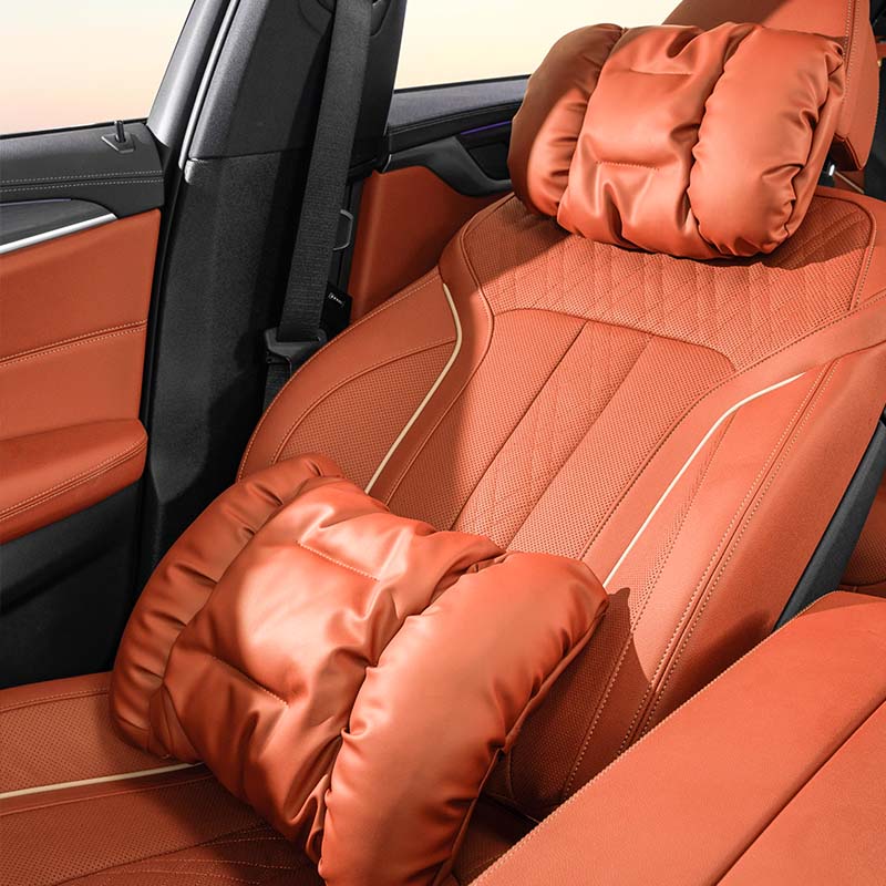 Nappa leather neck and lumbar support pillow installed on a dark-coloured seat