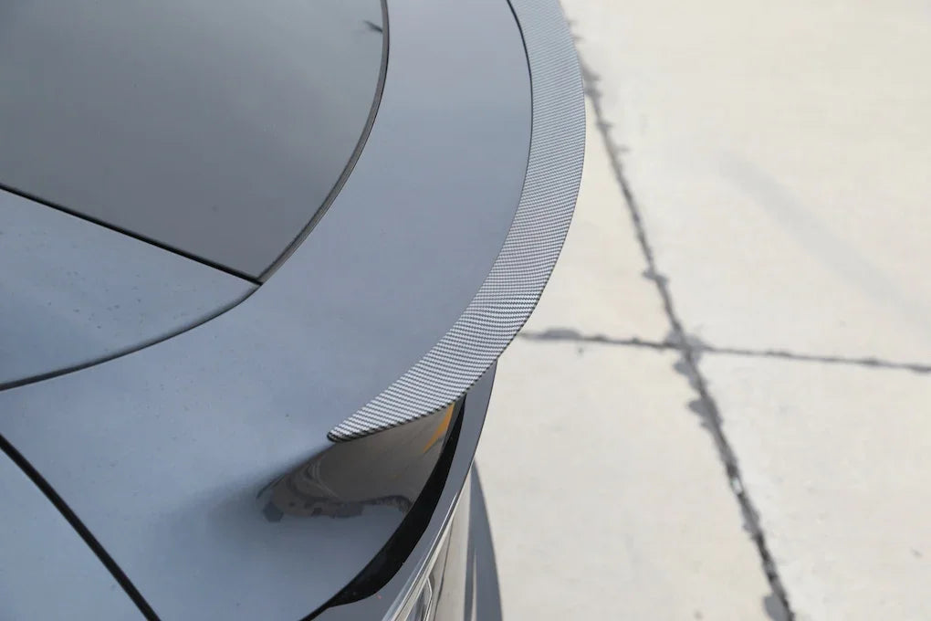 Performance spoiler installed on the rear tailgate of Model Y viewed from the right side
