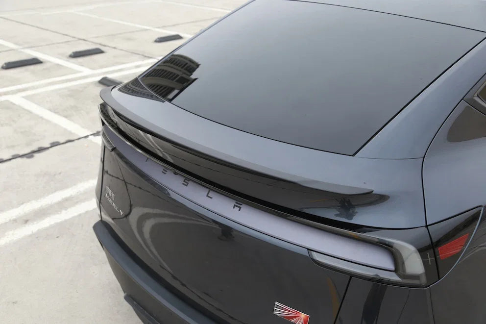 Rear three-quarter view of Model Y with the performance spoiler installed
