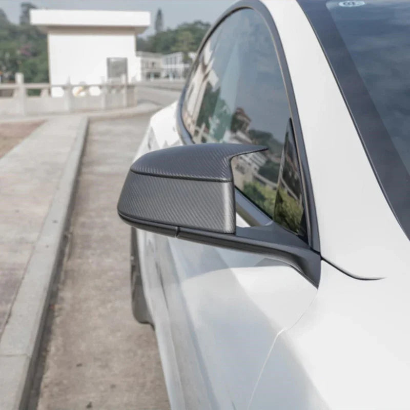 Side view of the rear view mirror covers installed on Model Y