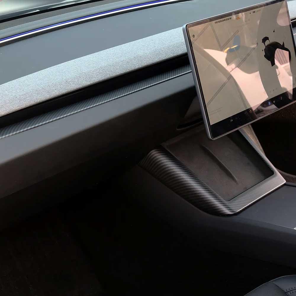Real carbon fibre charger surround framing the wireless phone charging area during use
