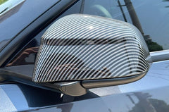 Side view of the rear view mirror covers installed on Model Y