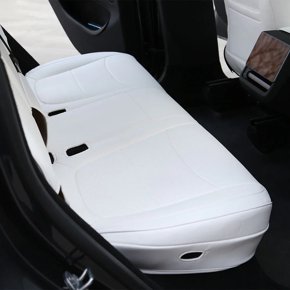 White seat covers maintaining rear seat folding functionality in Model Y