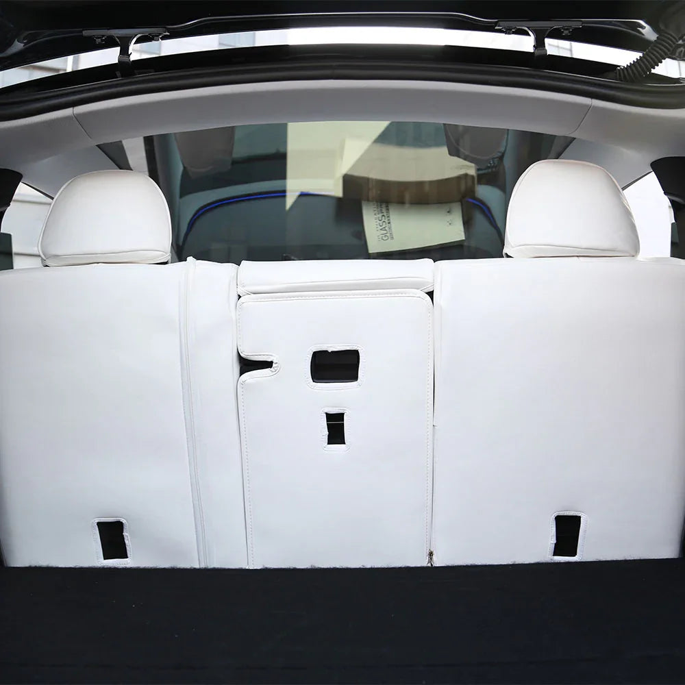 White microfibre leather covers protecting the rear seat backs of Model Y