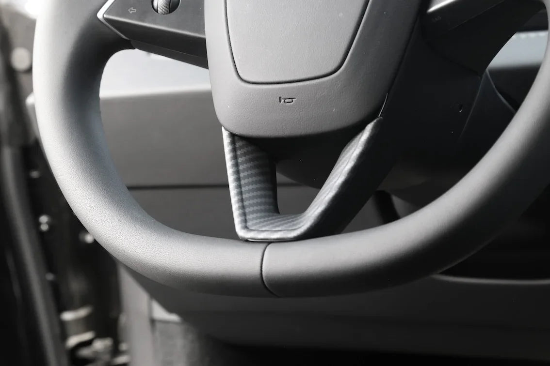 Steering wheel decorative overlay installed on Model 3 (2024–2026) and Model Y (2025–2026)