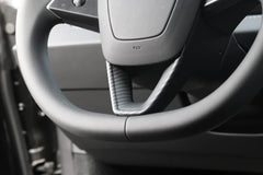 Steering wheel decorative overlay installed on Model 3 (2024–2026) and Model Y (2025–2026)