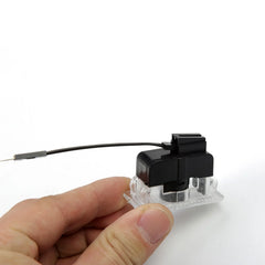 Plug-and-play Tesla puddle light with OEM-style connector