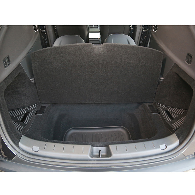 Trunk storage boxes installed in the rear cargo area of Model Y L creating additional hidden storage space