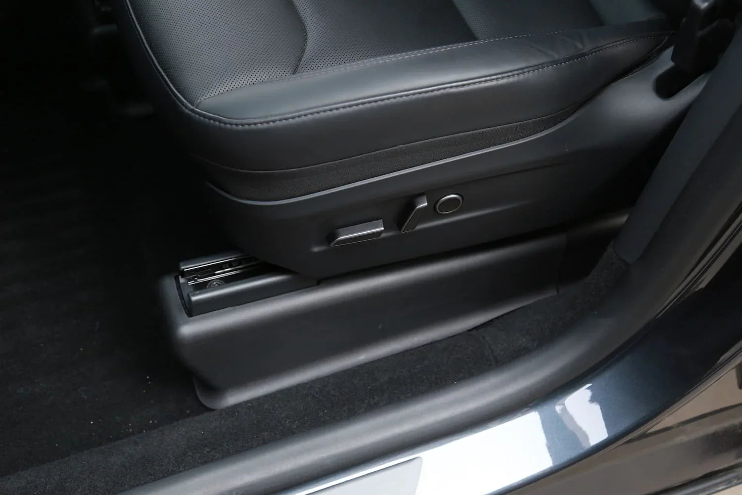 Under seat carpet protector installed beneath the driver's seat