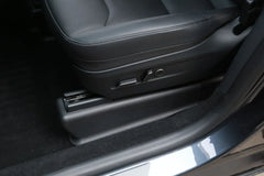 Under seat carpet protector installed beneath the driver's seat